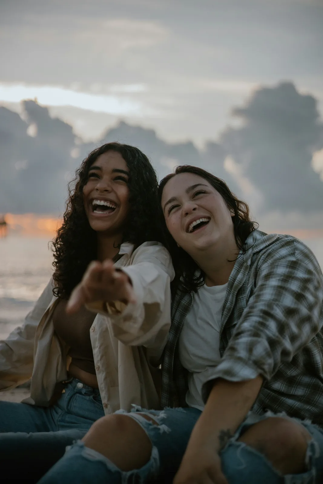 Two friends laughing together outdoors